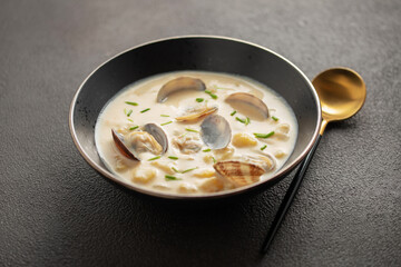 Clam chowder.  In addition to clams, common ingredients include diced potatoes, cream, carrots, and onions. Traditional American cream soup.