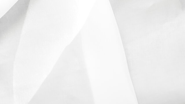 Soft white tulle fabric background creating an airy light texture for elegant visuals.