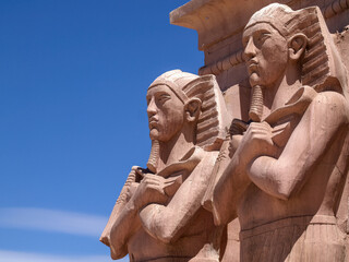 stone pharaoh guardians against blue sky
