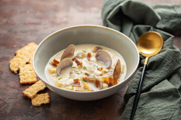 Clam chowder. Traditional American cream soup with clams,  potatoes, bacon, carrots, and onions
