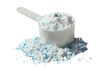 A scoop of white and blue speckled powder spilling onto a dark surface