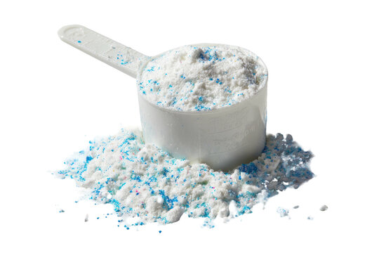 A scoop of white and blue speckled powder spilling onto a dark surface