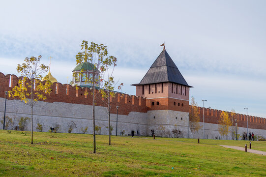 TULA, RUSSIA - NOVEMBER 2, 2025: People relaxing in the park near the walls of the Tula Kremlin and the 'Bashnya na Pogrebu' Tower on a sunny autumn day.