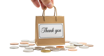 Hand holding a thank you gift bag surrounded by assorted coins isolated on black background