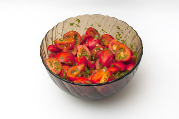 Fresh Appetizer: Sliced Tomatoes with Greens in a Clear Bowl