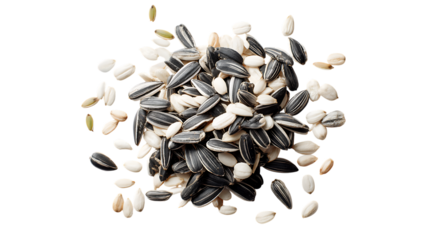 Scattered sunflower seeds, both whole black striped seeds and peeled white seeds