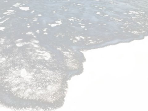 Texture of sea waves with white foam on a sandy beach, isolated transparent