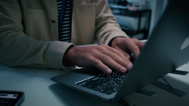 Programmer typing write code working on laptop computer at tech office. Close-up of Male Software developer, Businessman hand typing on keyboard. Software development and Cyber security concept.