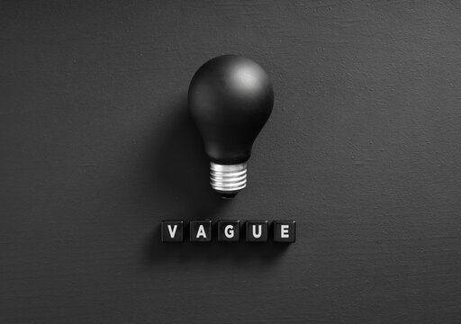 Black light bulb and the word vague illustrating lack of ideas