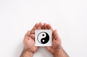 Man holding yin and yang symbol of balance and harmony