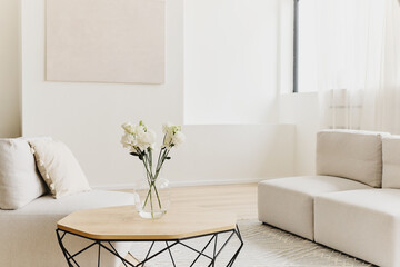 Bright Minimal Living Room With Flowers in Glass Vase.