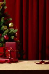 A vertical image featuring a Christmas tree and red gifts set against a rich red curtain. The elegant combination of colors creates a luxurious holiday backdrop.