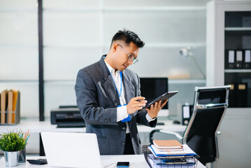 Mature business man executive manager looking at laptop watching online webinar training or having virtual meeting video conference doing market research