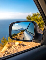 Scenic coastal road reflected in car mirror