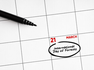 Calendar showing international day of forests on march 21st with black marker pen