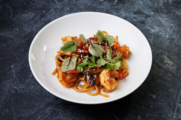 Spicy noodles with chicken, peppers, fresh herbs, and sesame seeds