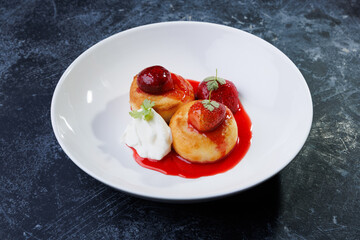 cottage cheese with strawberry red sauce in a white bowl
