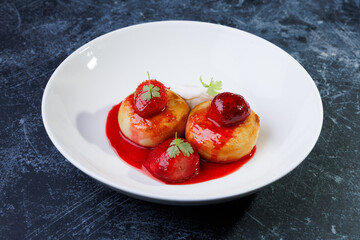 cottage cheese with strawberry red sauce in a white bowl