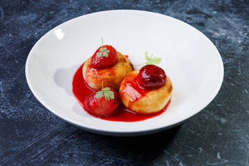 cottage cheese with strawberry red sauce in a white bowl