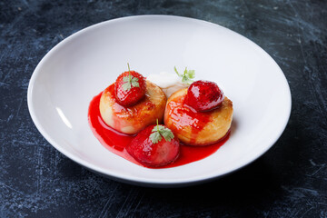 cottage cheese with strawberry red sauce in a white bowl