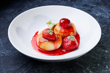 cottage cheese with strawberry red sauce in a white bowl