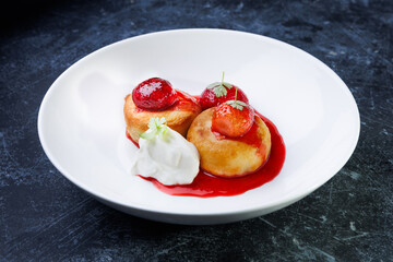 cottage cheese with strawberry red sauce in a white bowl