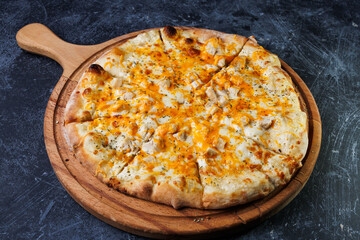 Cheesy Chicken Pizza On Wooden Board With Golden Crust And Melted Cheese