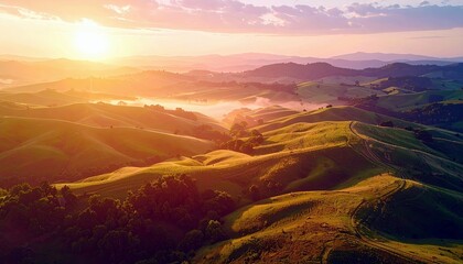 A breathtaking aerial view of sun-drenched rolling hills bathed in the warm glow of a sunrise, with mist settling in the valleys.