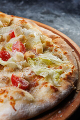 Delicious Caesar Pizza With Cheese, Tomatoes, Salad Leaves, and Crispy Toppings