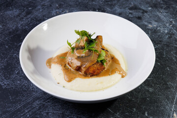 Gourmet Plate With Creamy Puree, Tender Meat, And Herb Garnish