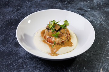 Gourmet Plate With Creamy Puree, Tender Meat, And Herb Garnish