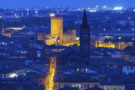 View of the illuminated Castelvecchio castle and the church of San Lorenzo, Verona, Veneto, Italy