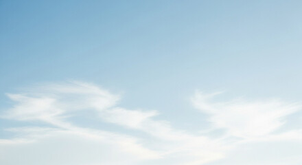 Wispy White Clouds in a Clear Light Blue Sky Background image photo