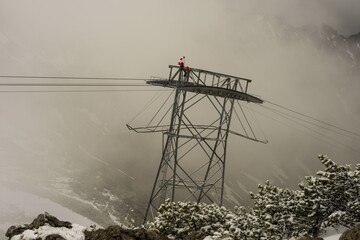 Cable car technicians working in bad weather conditions, Nebelhorn cable car near Oberstdorf, Allgäu Alps, Allgäu, Bavaria, Germany