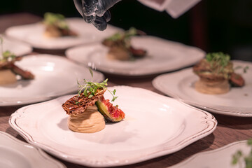 A plate of food with a garnish of green vegetables on top