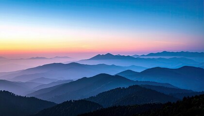 A panoramic view of multiple mountain ranges receding into the distance, bathed in the soft hues of a sunrise.