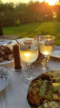 Romantic dinner outdoors on sunset. 
