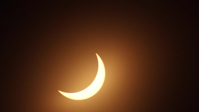 Stunning video of a partial solar eclipse creating a glowing crescent shape. Solar eclipse of April 8, 2024