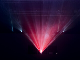 cinema projector with colored light beams that fan out from a central source, creating an intense and enveloping scenographic effect.