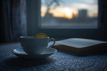 A quiet porcelain teacup rests by the window as dusk settles into gentle calm