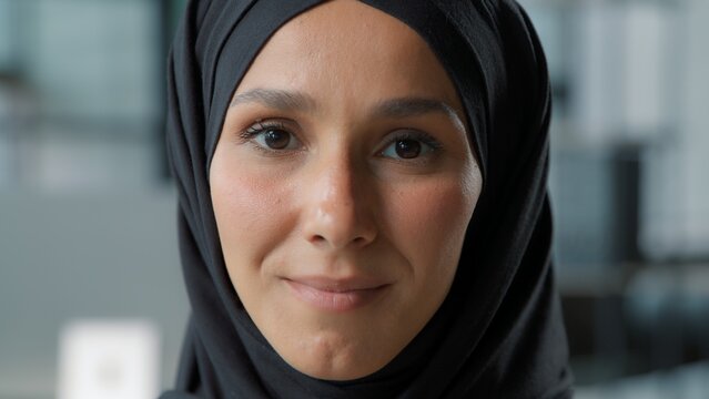Female portrait close-up arabian smiling cute Muslim business woman in hijab businesswoman muslim islamic girl worker smile looking at camera in office workplace beautiful face positive ethnic lady - Powered by Adobe