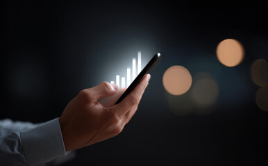 Focused business person holding smartphone showing glowing digital graph. technology represents financial growth, stock market investment and data analysis