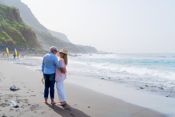 lifestyle with caucasian senior couple resting on beach, happy in love romantic and relax time, tourism of elderly family pleople, leisure and activity travel after retirement in vacations and summer