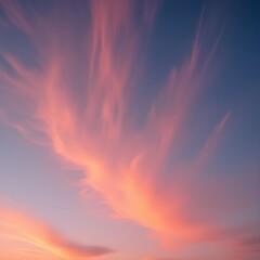 Sun paints orange hues on fluffy clouds at sunset.