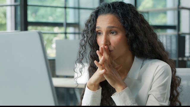 Worried confused Hispanic business woman reading bad news on computer puzzled with online work task businesswoman ethnic female girl worker manager with pc difficulty working feeling stressed error