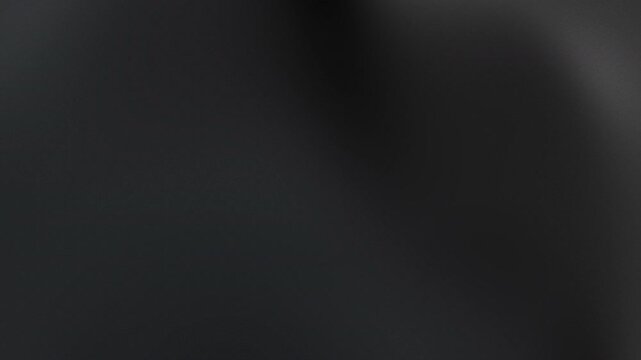 Blurry dark grey background with subtle lighting effects perfect for adding text overlays or creating a mysterious atmosphere in design projects.