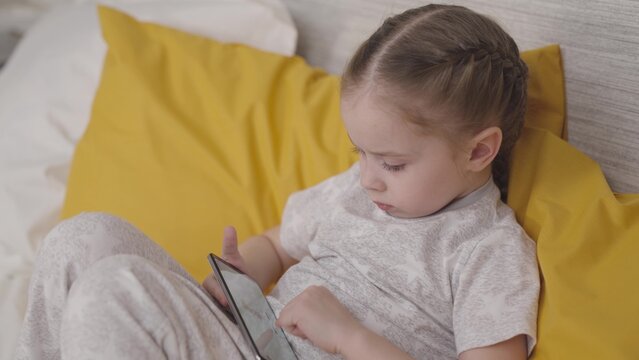 child learns through phone application, school student learns lessons, social childhood internet, children room with smartphone entertainment, touch smartphone with finger of hand, wireless technology