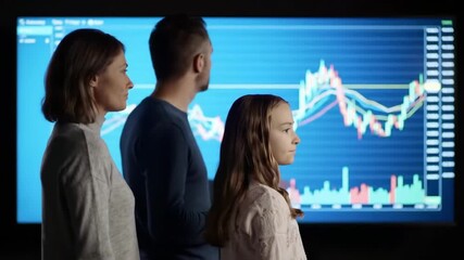 Family analyzing financial data on screen, discussing investments, in a modern living room, for financial literacy - Powered by Adobe