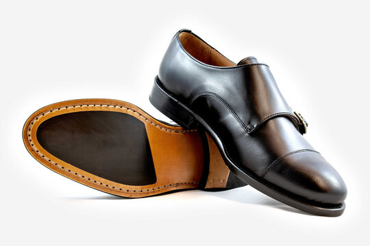 Classic buckle black leather shoes in a white background. 