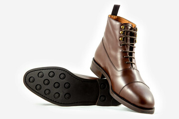 Classic light brown leather shoes in a white background. 